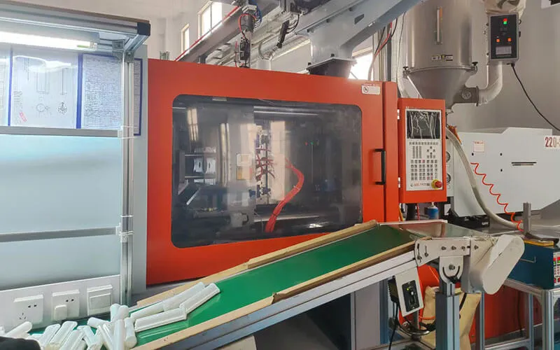 Injection molding machine production line for plastic 2K dual glue cartridge manufacturing in factory workshop